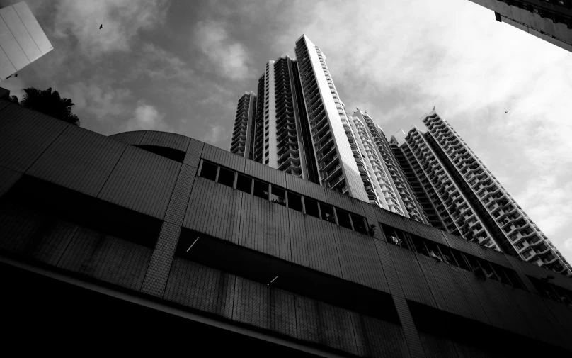 black and white pograph of tall buildings with one building next to another