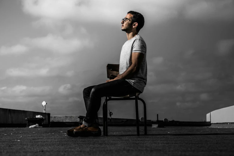 a man sitting on a chair in an empty space