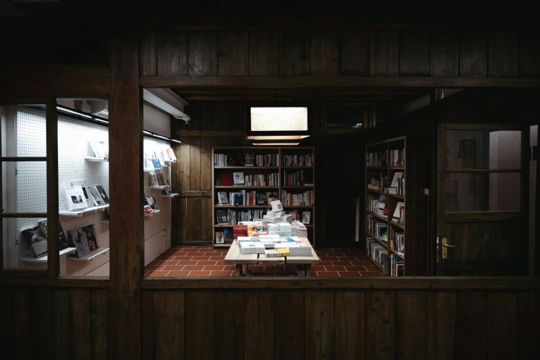 an open house with bookshelves, a window and an old fashioned table