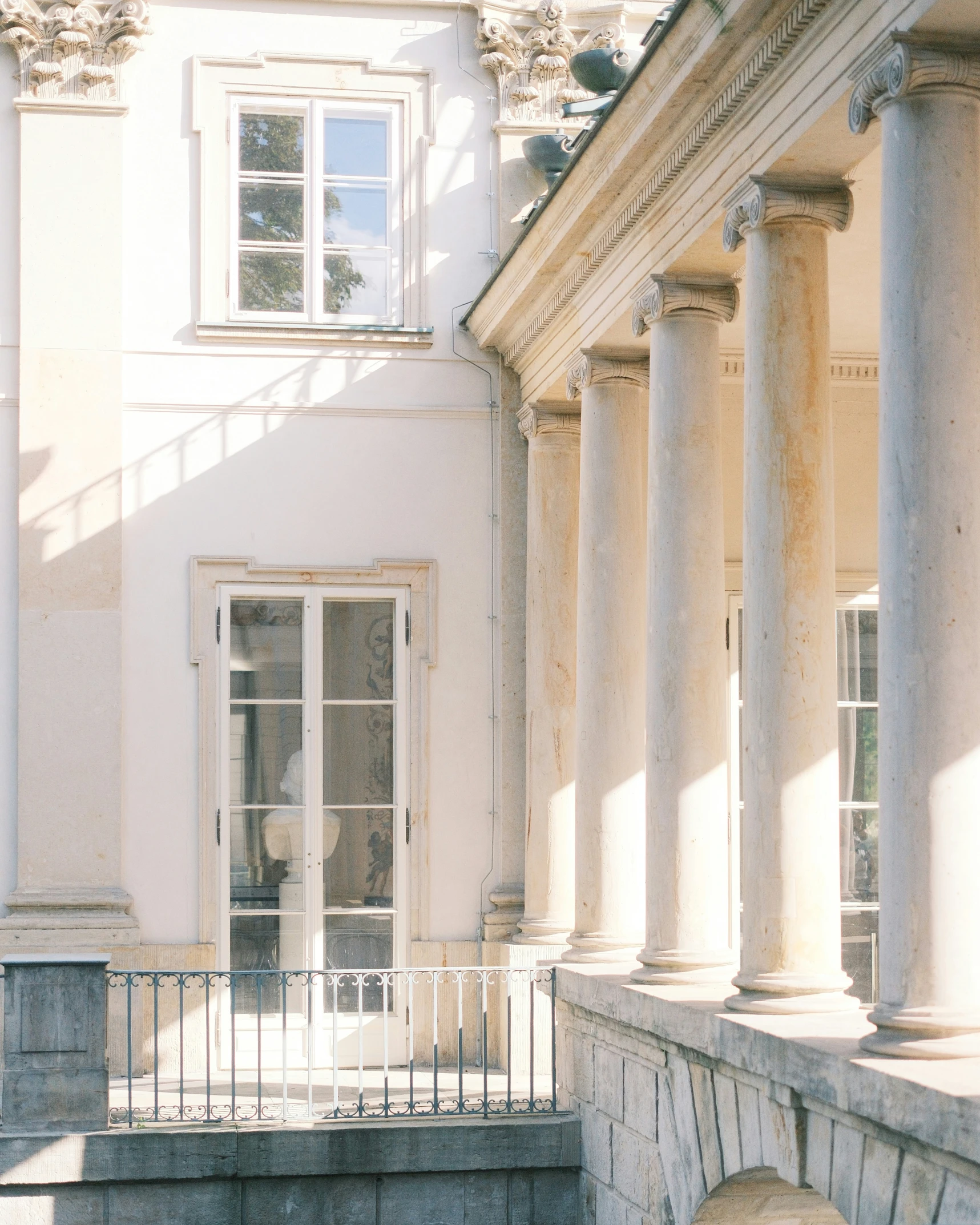 there are columns in front of the building with windows