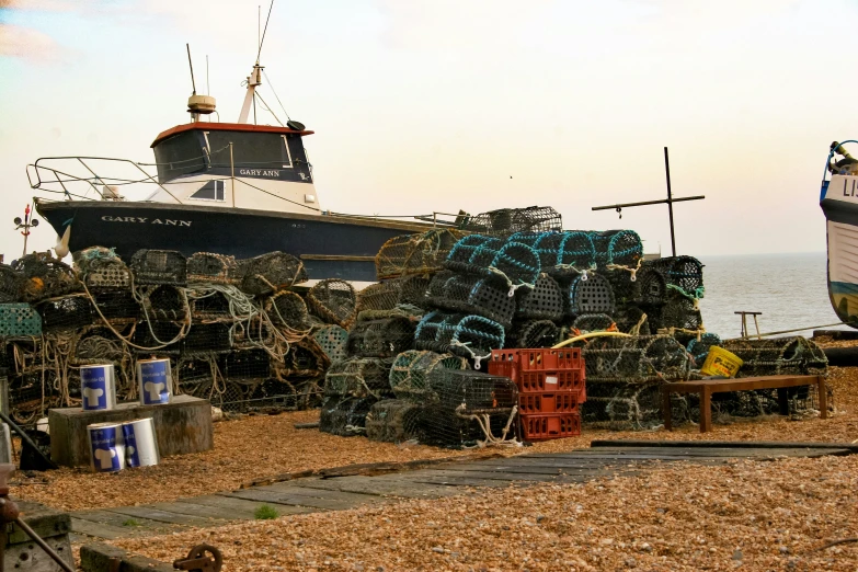 a row of boats that are on some sand