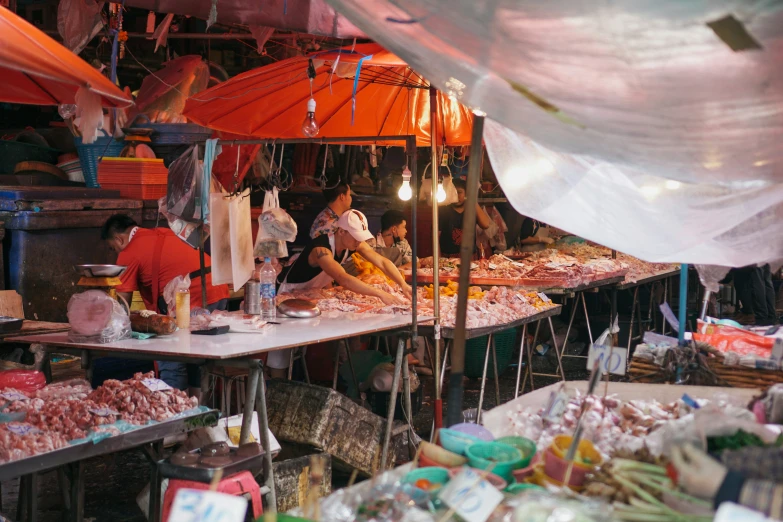 there are people at a food stand cooking food