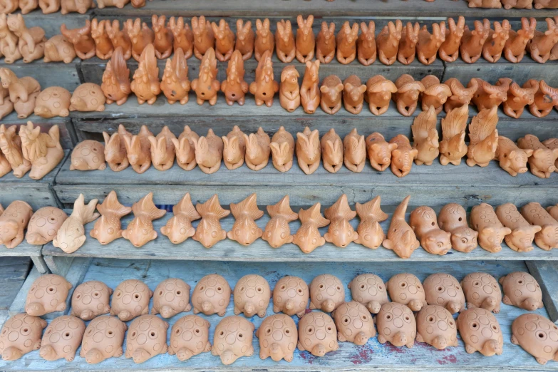 pottery is stacked on shelves in a store