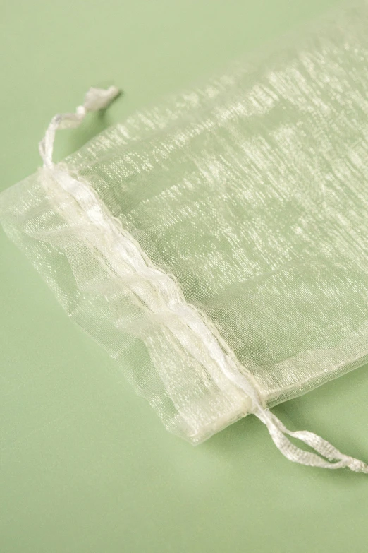 white sheer fabric is tied together with a ribbon