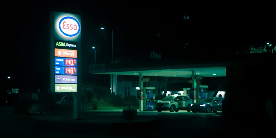 several trucks are parked in a gas station