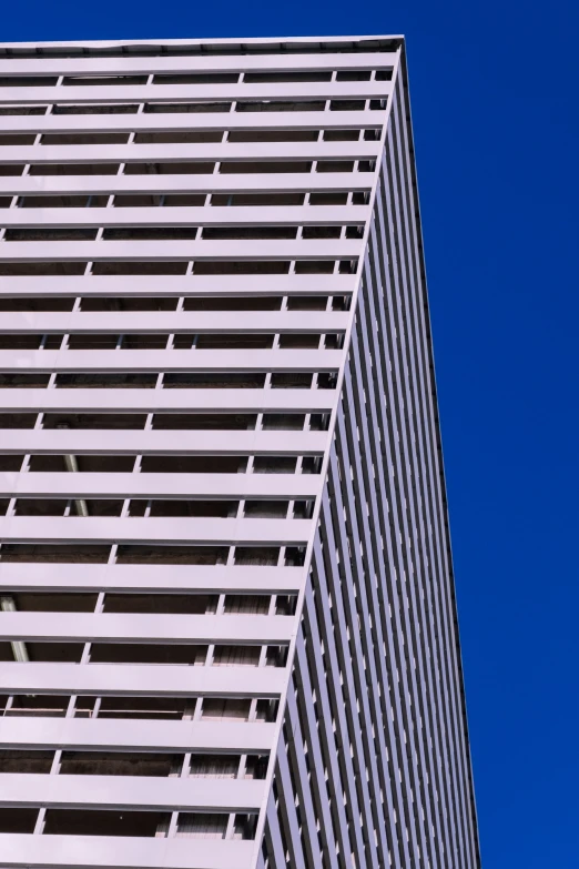 a clock is posted at the top of a tall building