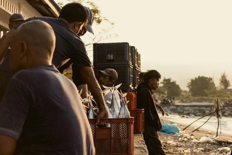 men at an open air market with crates