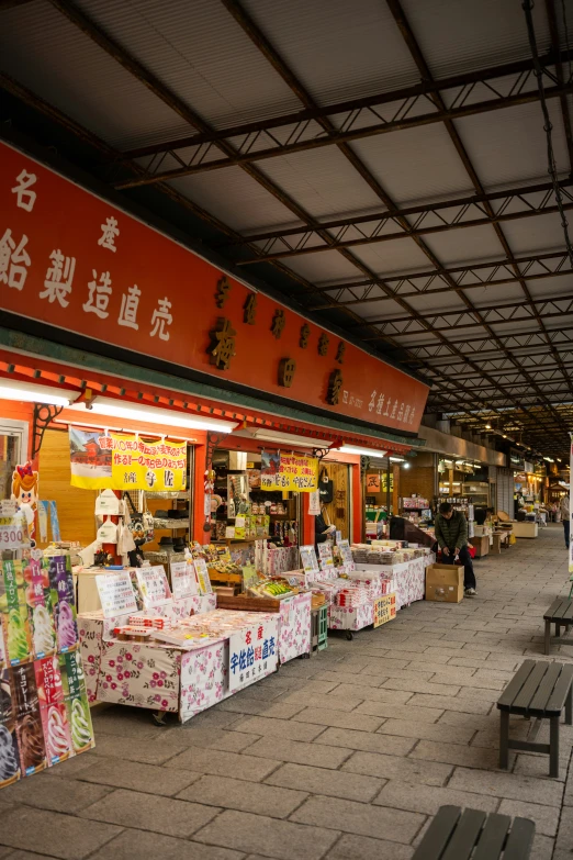 a large open market area with tables and benches