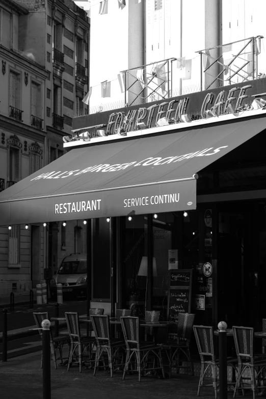 a black and white po of a restaurant with chairs