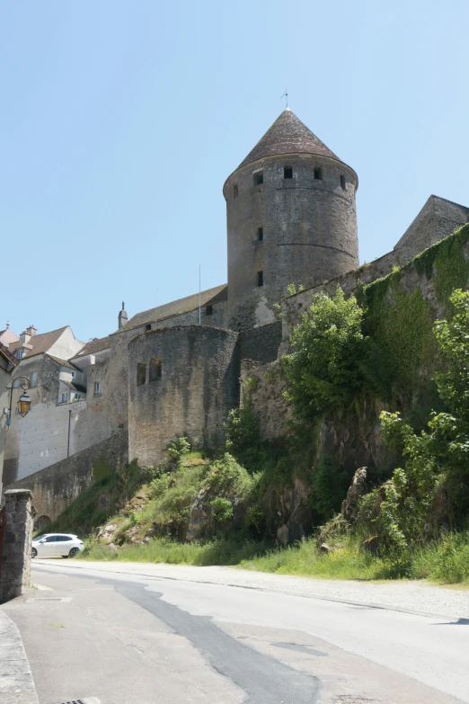 a street near an old castle with a mountain next to it