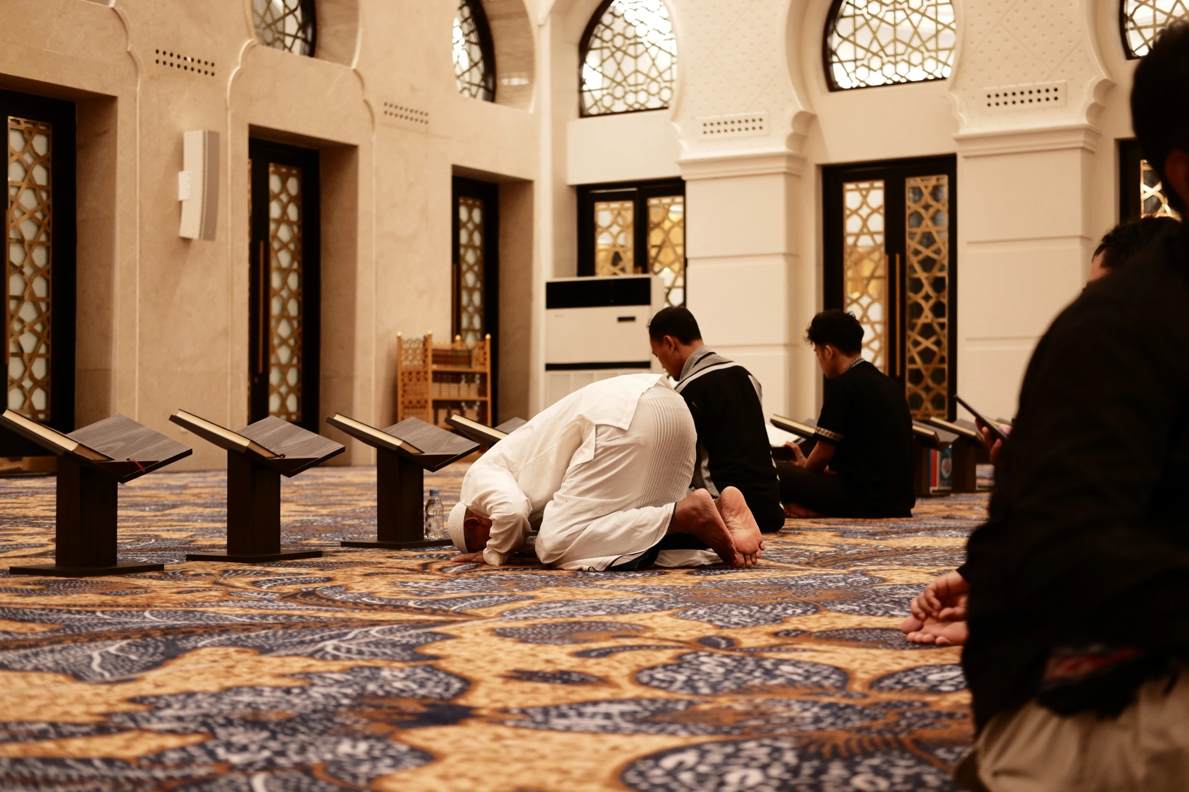 a couple of men sitting on the ground in a building