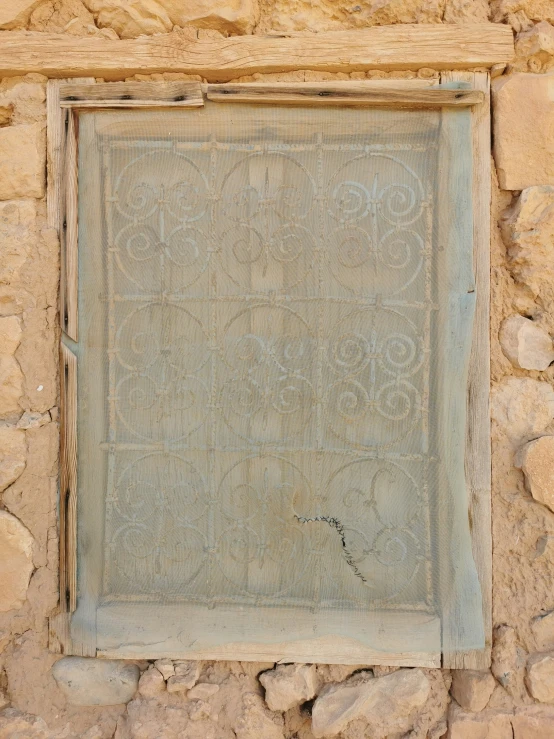 a square window with a grate at the bottom