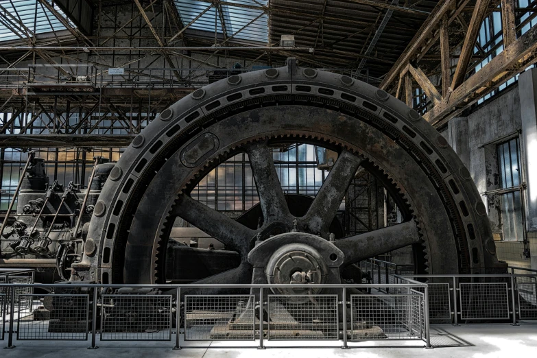 a large wheel in a building with a sky light