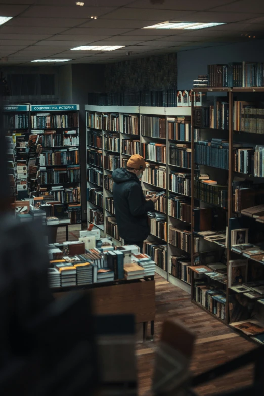 a person looks at a bookshelf in a liry