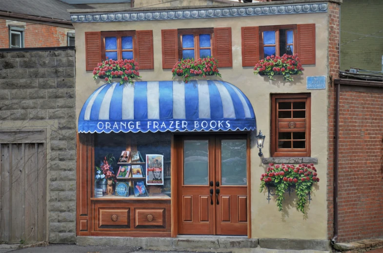 a small shop with a large striped awning