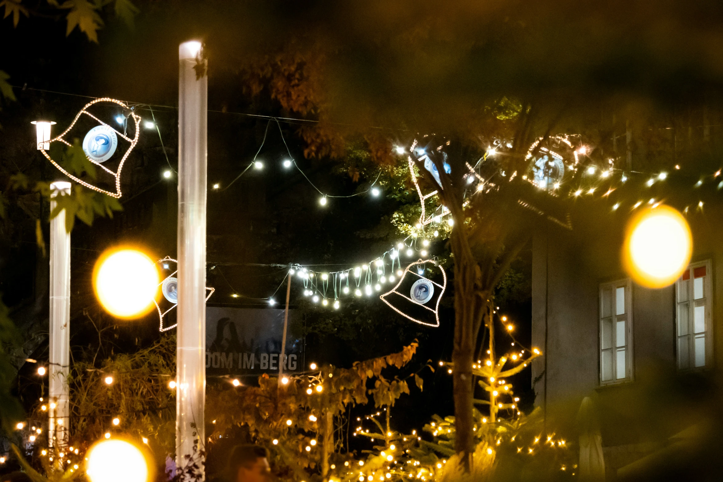 a number of lights are on a tree with a string of lights