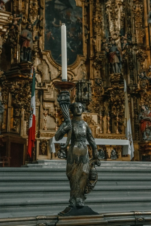 an ornate statue stands near the steps of a church