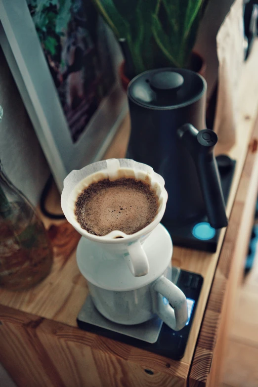 a cup of coffee and a phone on a table