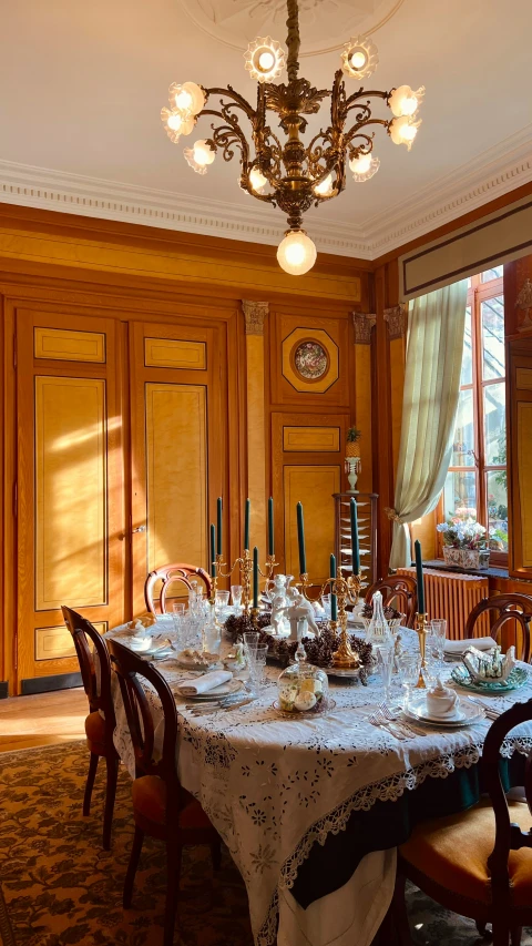 a formal dining room set with table settings and candles