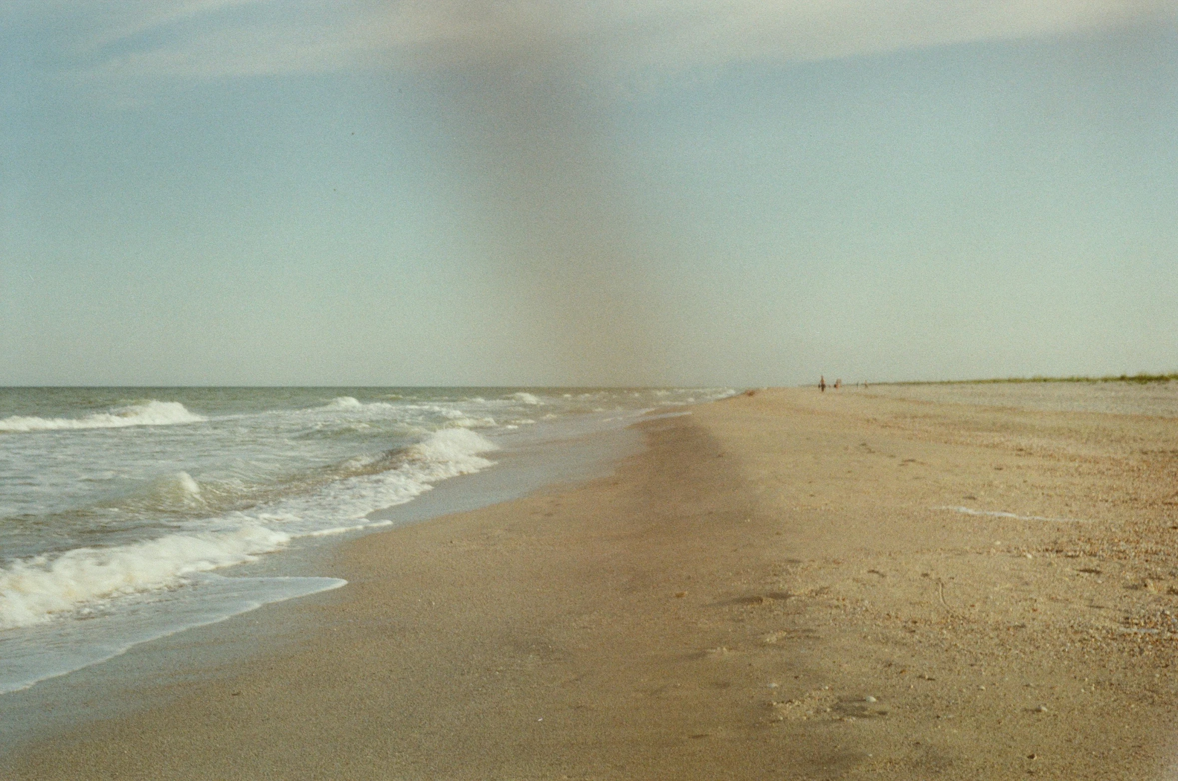 the beach is empty and the sky has clouds