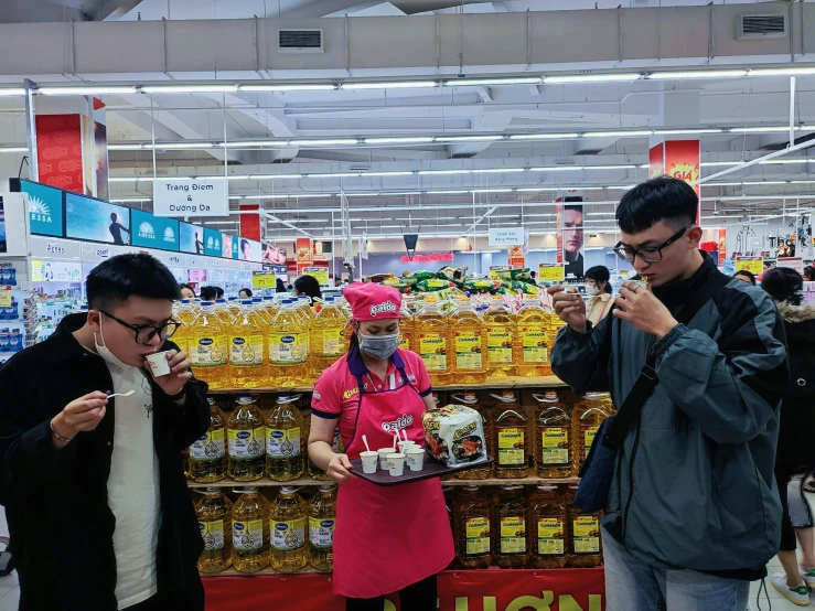 some people in a store with masks on and drinks