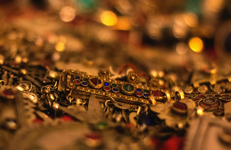 rows of gold and colored jewelry sit on display