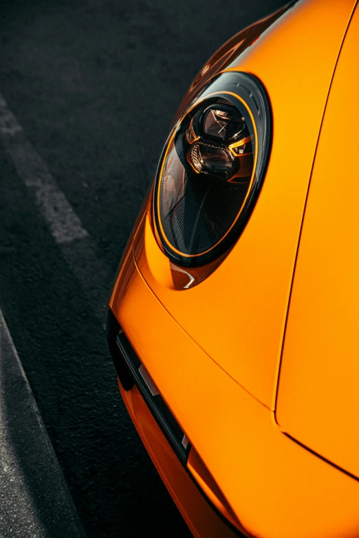 the front end of a bright orange car