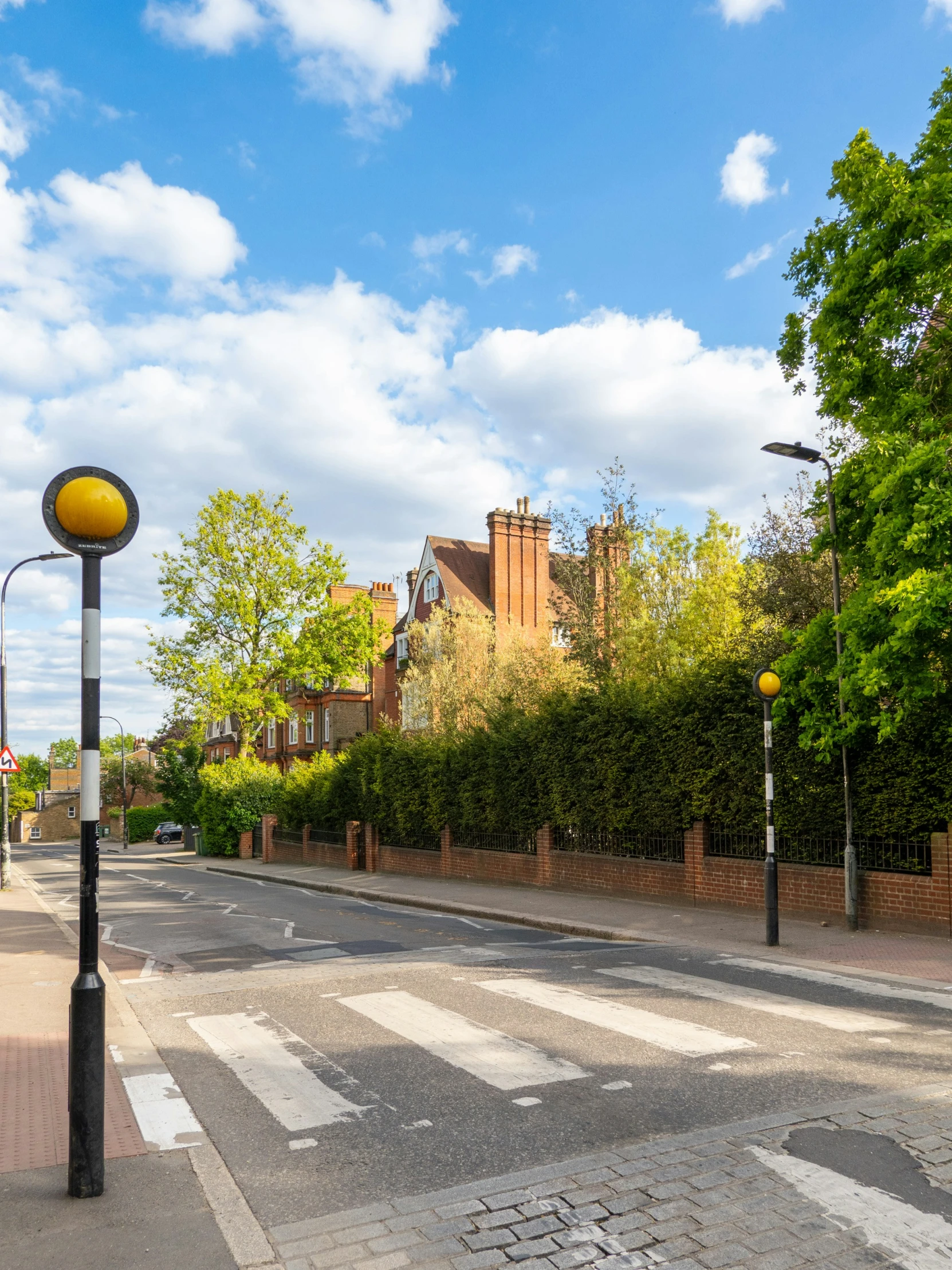 an empty street that is lined with trees