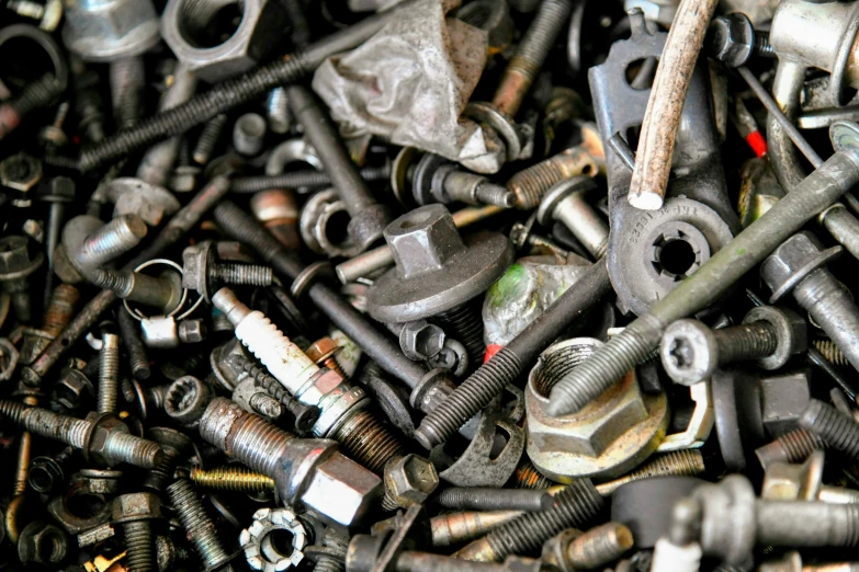 assortment of bolts and nuts grouped together in a pile