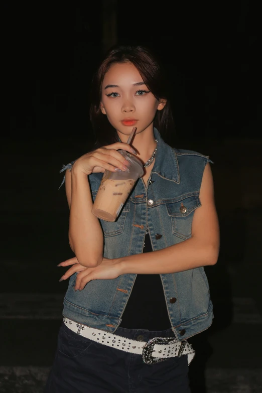 a female in a denim jacket posing for a picture