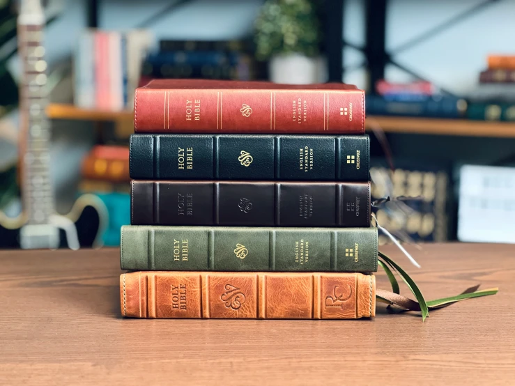 three books on a table with one open and one closed