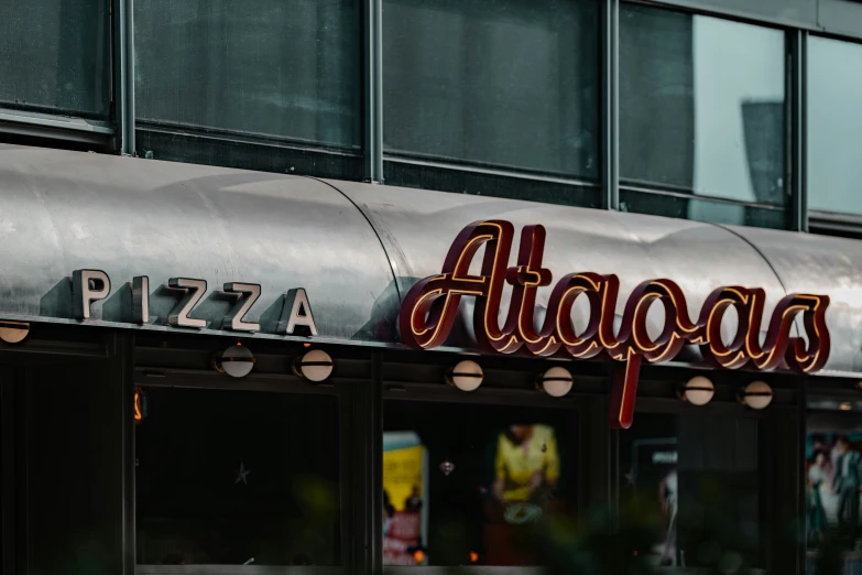 an attaquas sign on the front of a pizza shop