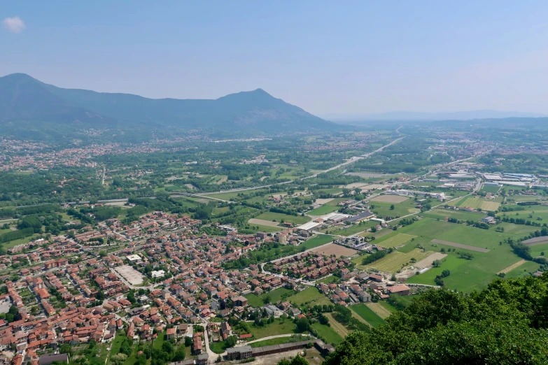 an aerial view of a city surrounded by mountains