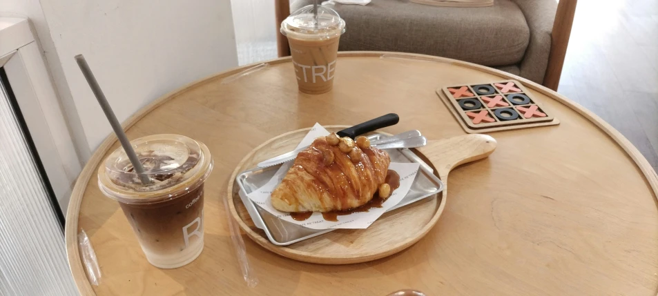 a brown table with plates and a cup of coffee