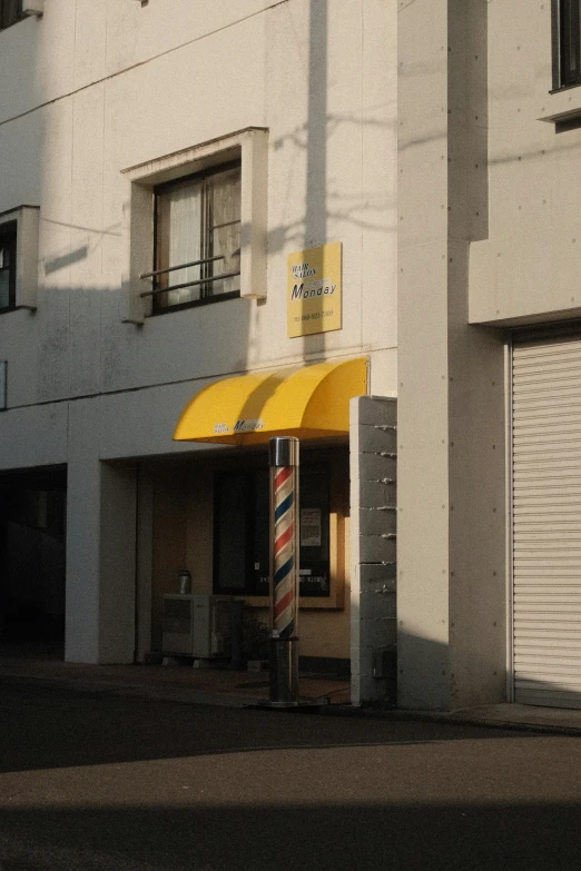 a store front with the yellow awning open