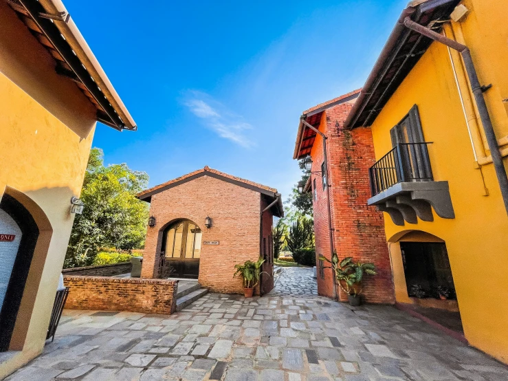 a brick street with small buildings on each side