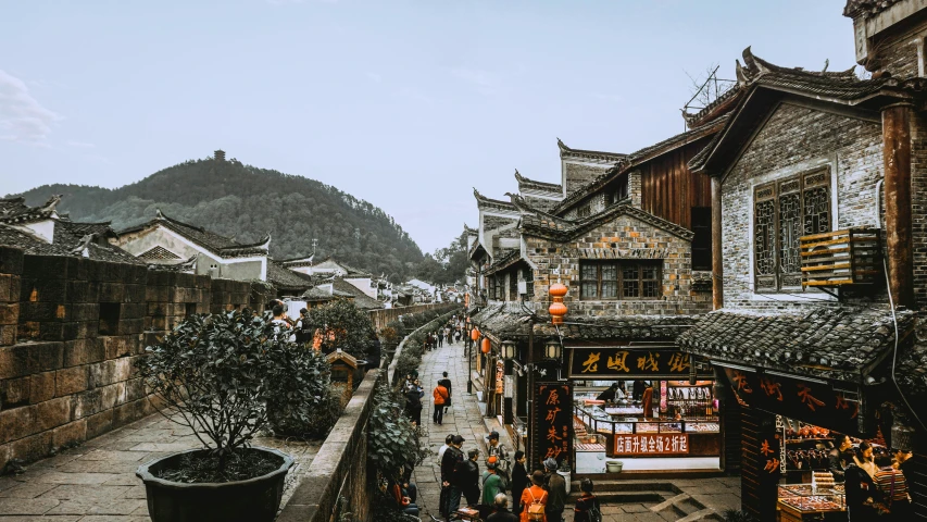 an outdoor view of a village near mountains