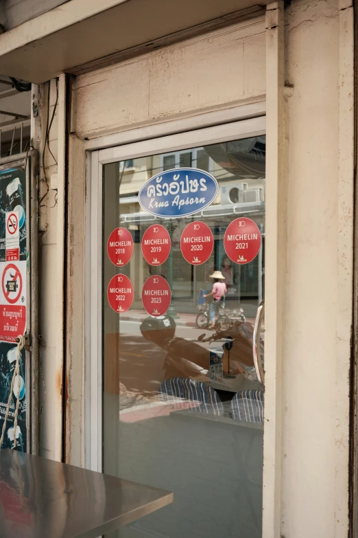 a po of a store front window with street signs