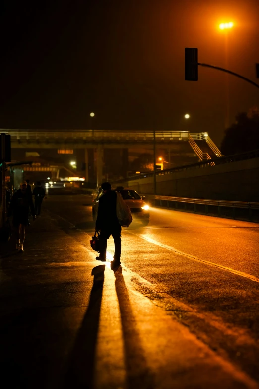 a person is walking down the street at night