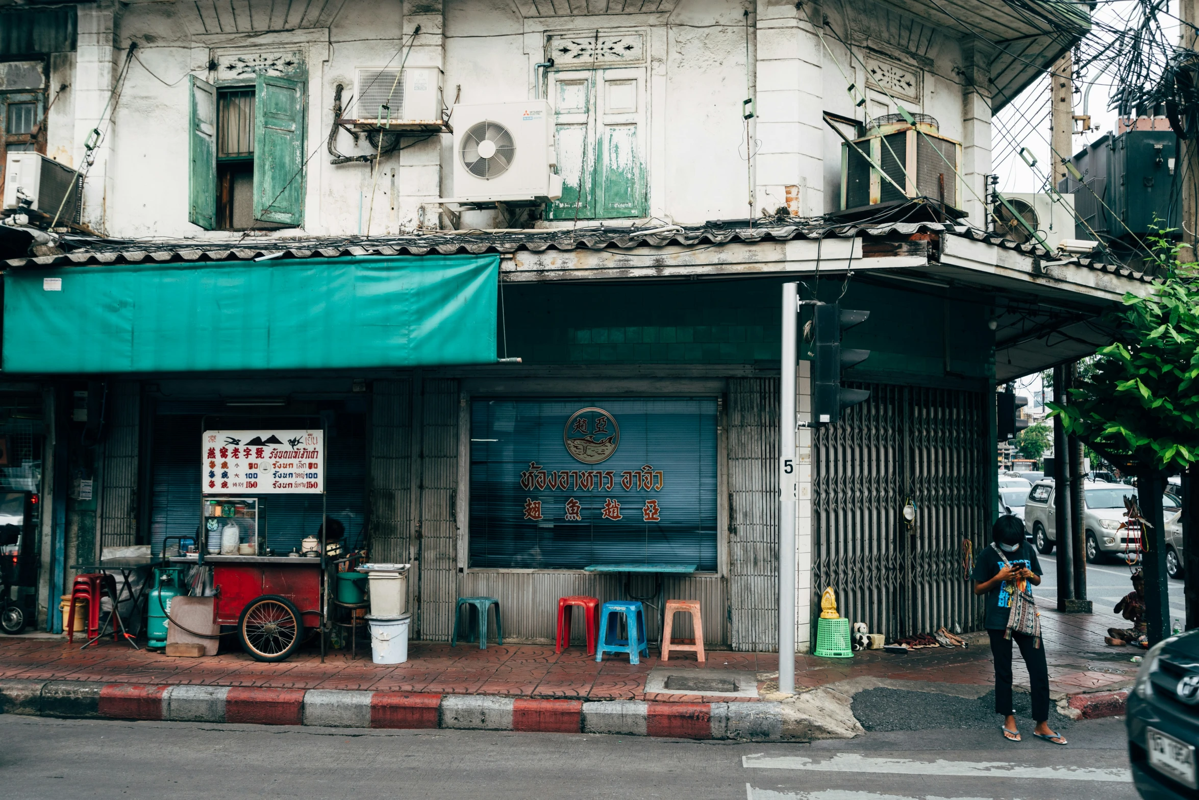 a person walking across a street past a building