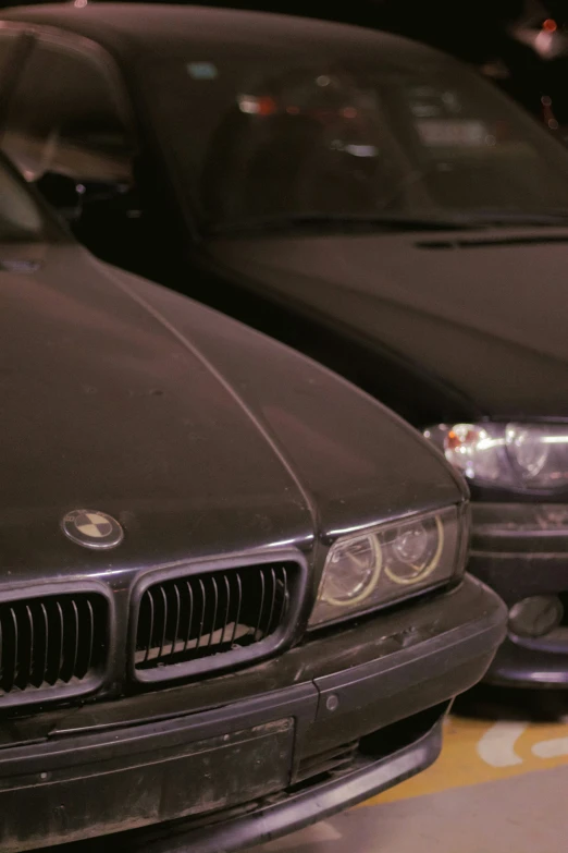 three old black cars lined up on display