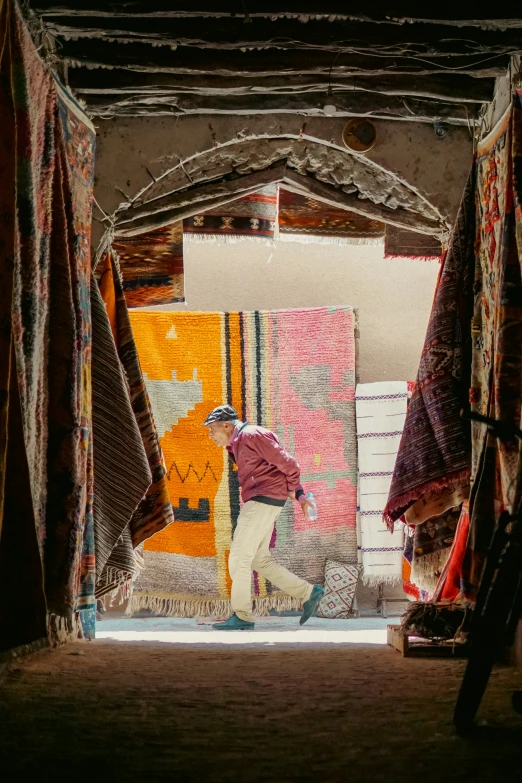 woman with quilts on the ground at an old weaving factory