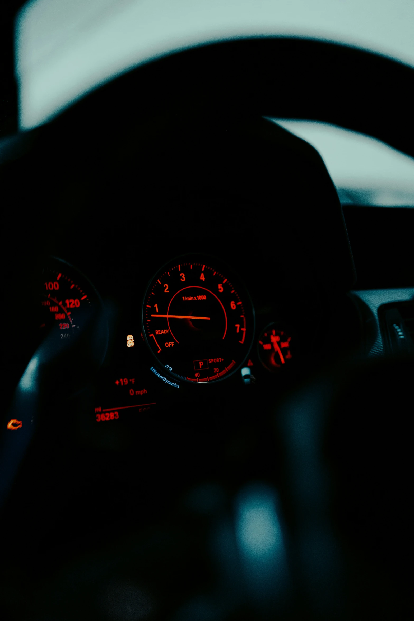 a dark pograph of a dashboard with various gauges