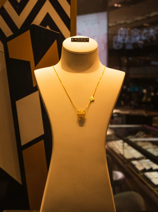 a necklace with several different shapes on display