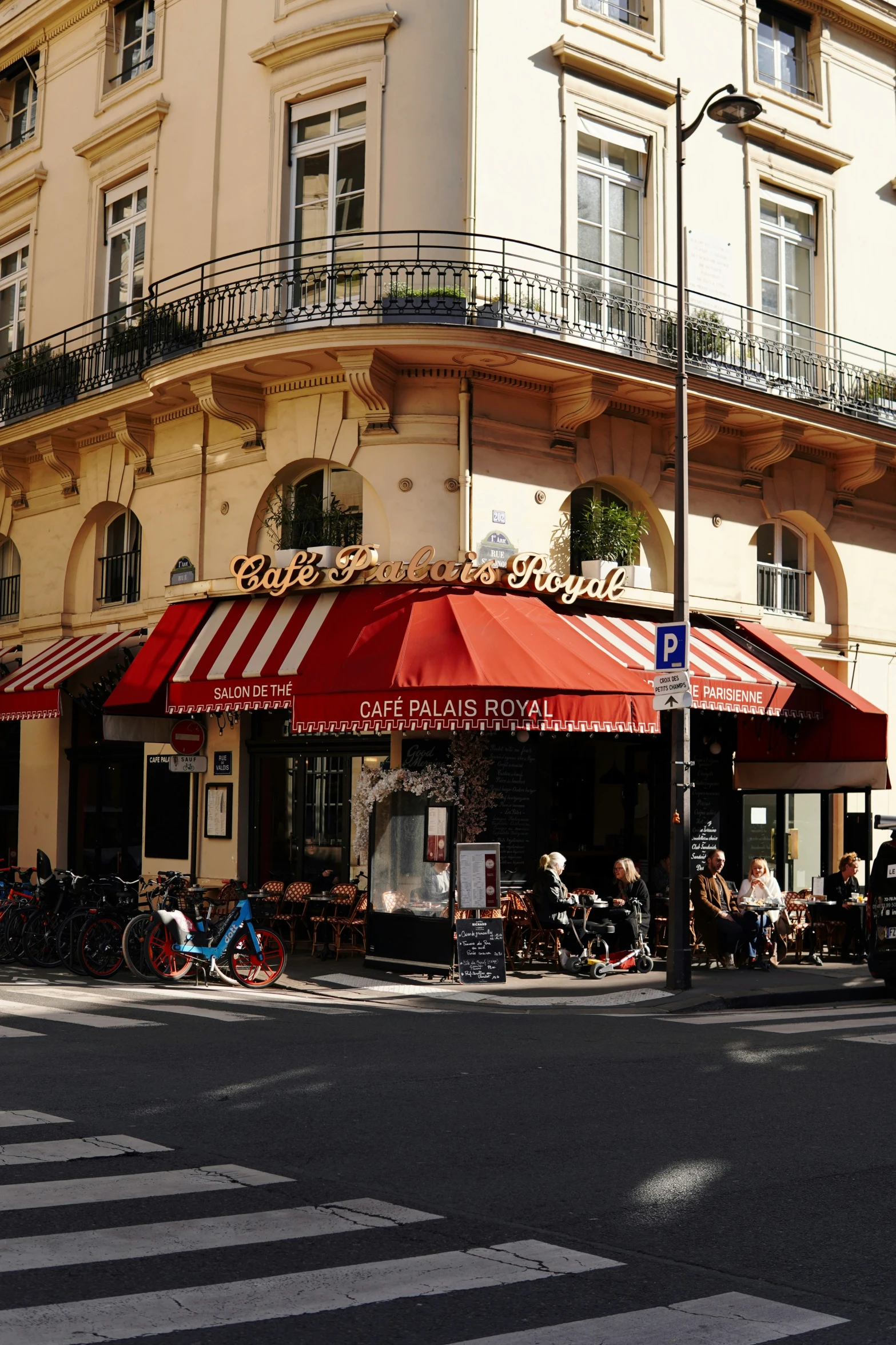 a busy street corner with red and white awnings