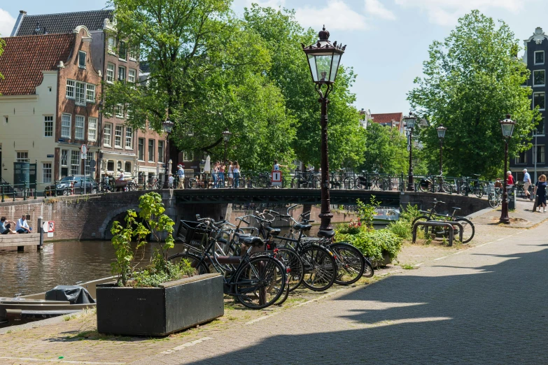 a street with people walking around a city next to a river