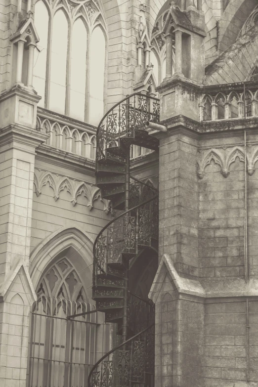 a large ornate stone building with stairs and arches