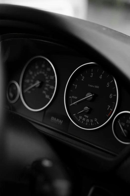 a black and white pograph of a steering wheel gauge