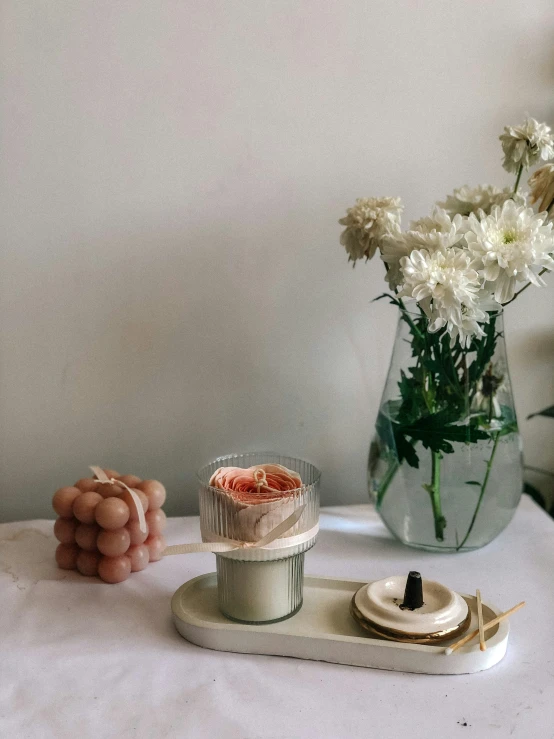 flowers and sweets in the form of objects in a vase