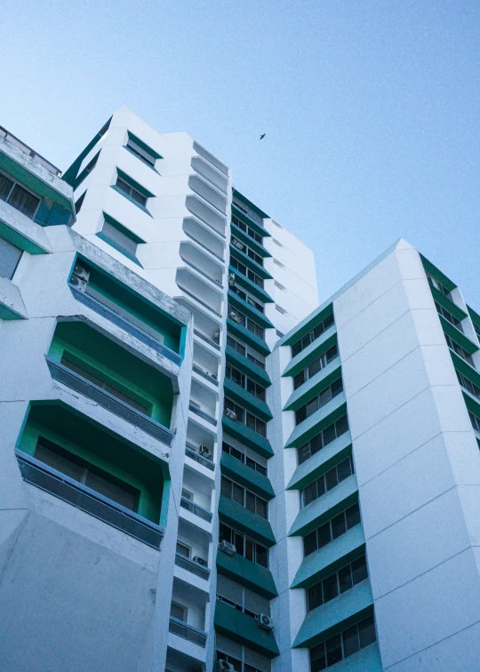 the exterior of a tall apartment building in an urban setting